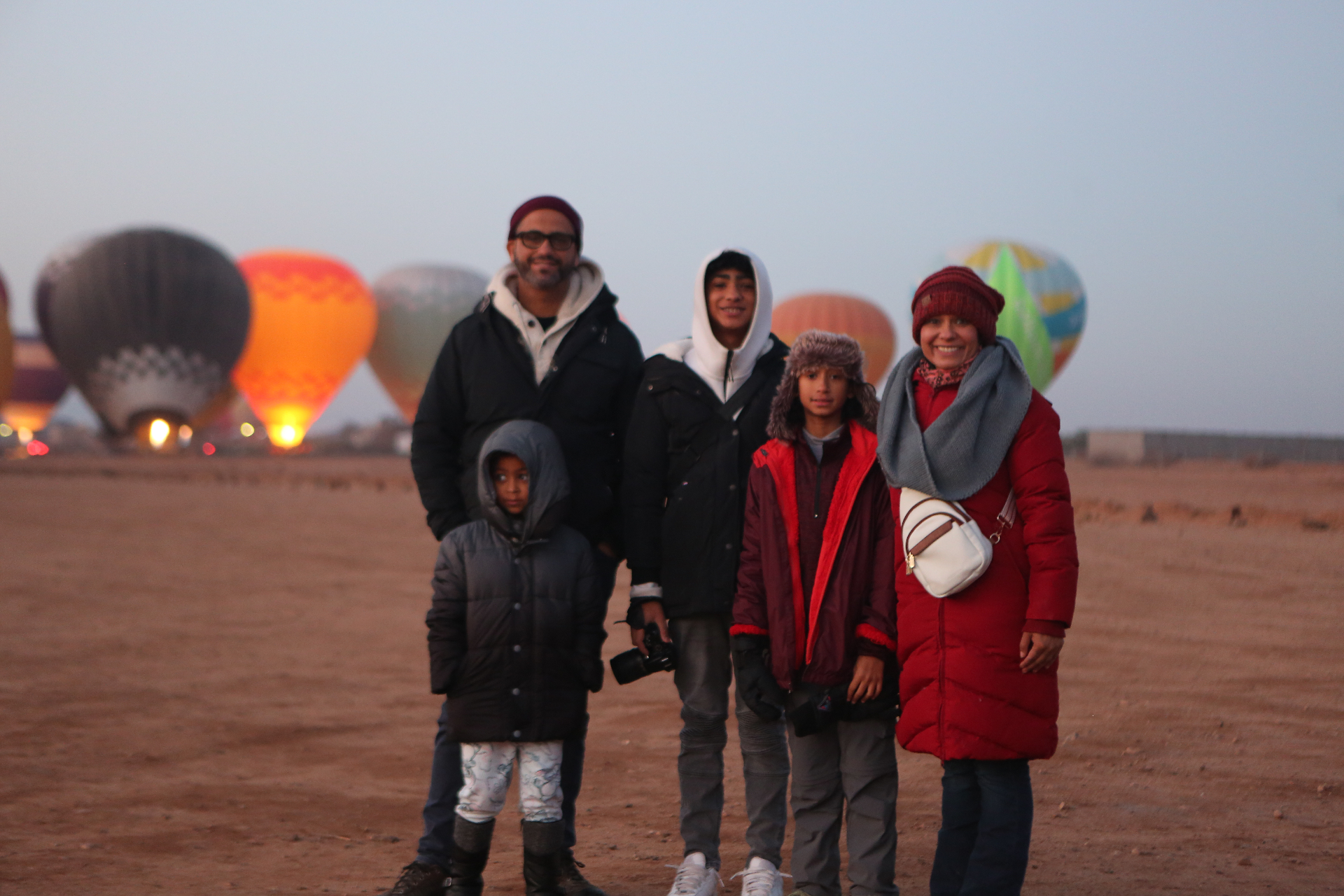 Family portrait at dawn with balloons in the background